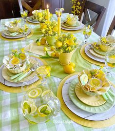 the table is set with lemons and dishes