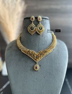 This Multicolor Cz Floral Golden Finish Necklace set is a classic choice for any wardrobe. Adorned with traditional South-Indian Temple jewelry, this necklace is an exquisite piece that is sure to impress. Crafted in high-quality materials, this necklace will last for years to come. It will come with Golden thread to tie Gold Kundan Necklace With American Diamond For Anniversary, Kundan Necklace With Cubic Zirconia As A Gift, Cubic Zirconia Kundan Necklace With Intricate Design As Gift, Heavy Diamond Necklace For Celebrations, Elegant Multicolor Hand Set Bridal Sets, Elegant Multicolor Bridal Sets With Stone Work, Elegant Multicolor Bridal Sets For Festive Occasions, Hand Set American Diamond Chandbali Necklaces, Festive Cubic Zirconia Necklaces Hand Set