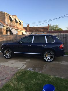 a black suv parked in front of a house