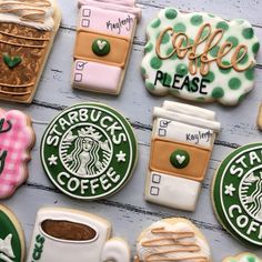 cookies decorated like starbucks coffees and hot chocolate are arranged on a white wooden surface