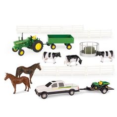 toy farm vehicles and horses on a white background with a green tractor, black and white horse in the foreground