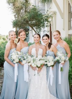 the bride and her bridesmaids pose for a photo