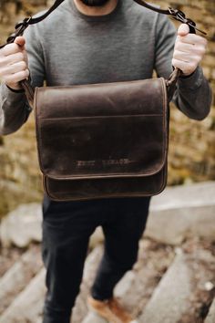 If you think it is time to ditch your old, tired-looking messenger bag, then check out our newest addition to the ever-popular shoulder carryall. No polyester material or plastic buckle in sight, this handcrafted messenger bag shows off high quality saddle leather and antique-coloured hardware. Long-term use will produce a deeper tone in the leather, adding character to it and enhancing the bag’s overall appearance. Based on the traditional school satchel design, the bag has a large flap closure Rectangular Leather Satchel For Outdoor, Outdoor Leather Shoulder Saddle Bag, Outdoor Rectangular Leather Satchel, Outdoor Satchel Shoulder Bag With Luggage Sleeve, Rectangular Leather Shoulder Bag For Outdoor, Classic Rectangular Briefcase For Outdoor, Outdoor Rectangular Leather Bag, Outdoor Satchel Shoulder Bag With Leather Lining, Rectangular Leather-lined Shoulder Bag For Outdoor