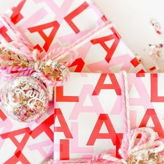 presents wrapped in pink and white paper on top of each other