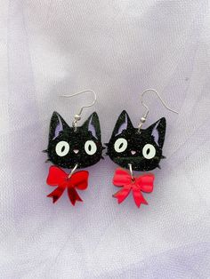 Earrings inspired by Kiki's faithful sidekick and best friend. Jiji is made with black glitter acrylic, with hand-painted features, and vinyl cut eyes. His bow is made with red mirror acrylic! Jiji is about 5 centimeters with his bow! Light weight and fun accessory for any Studio Ghibli fan! Kikis Delivery Service Earrings, Bow Light, Weird Jewelry, Acrylic Earring, Fancy Cats, Red Mirror, Funky Earrings