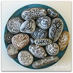 some rocks have been decorated with flowers and happy birthday written on them in white ink