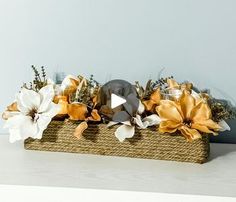 a basket filled with flowers sitting on top of a table