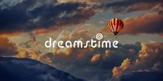 a hot air balloon flying in the sky with words dreamtime on it's side