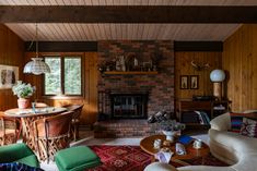 a living room filled with furniture and a fire place next to a table on top of a rug