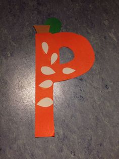 the letter p is made out of paper and has leaves on it's side