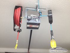 two wires are connected to an electrical device on the ceiling with red and yellow cords