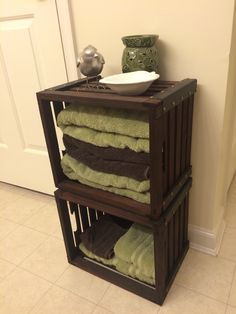 a stack of towels sitting on top of a wooden shelf