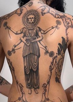 the back of a woman's body with tattoos on her chest and arms,