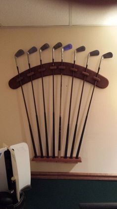 there are many golf clubs hanging on the wall