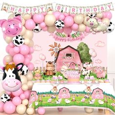 a birthday party with balloons and farm animals on the table in front of a pink barn