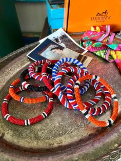 This stack is beautiful on your arm  Gorgeous set of vintage Handmade Maasai Beaded bracelets.  9 total.  Purchased directly from the maker in 1990 in Kenya.  Special pieces!  Sizes and colors vary!  Keep them to yourself, or share as precious gifts! P.S...take a fun browse through the boutique - lots of rare luxury currently available - more always arriving.  Happy to ship your treasures together!   THX for shopping with me ~ Follow along on IG @laughincolorstudio for styling, vintage luxury and original ART ~ Questions welcome and additional pictures may be requested prior to purchase.   Domestic USA shipping.   Please honor your purchase contract by making payment promptly - help to keep Etsy fun for everyone!   Final Sale,  please,  so use the Enlarge feature on the pictures - it will Unique Beaded Bracelets For Festivals, Traditional Red Beaded Bracelets With Large Beads, Artisan Beaded Bangle Bracelet With Large Beads, Artisan Bangle With Large Beads, Artisan Beaded Bangle Bracelets For Festivals, Traditional Handmade Beaded Bracelets For Festivals, Hand-strung Vintage Multicolor Beaded Bracelets, Artisan Red Bracelets With Large Beads, Traditional Round Beaded Bracelets For Festival