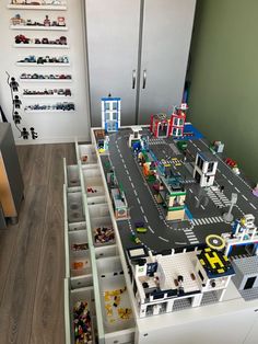 a toy city with cars, trucks and buildings