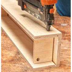 a piece of wood is being used to make a drawer for a power driller