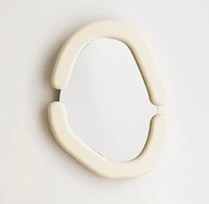 a white mirror mounted to the side of a wall