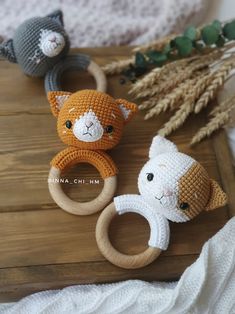 three crocheted animals sitting on top of a wooden table next to each other