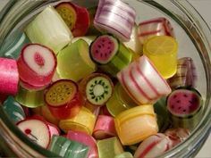 a glass jar filled with lots of different types of fruit slices on top of each other