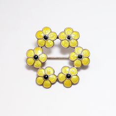 "This is a pretty Mid Century butterfly brooch by MEKA, Denmark. The piece is signed on the back and hallmarked Sterling silver. The brooch is made of Sterling silver and bright yellow guilloche enameled daisies with black centers. The brooch is in very good vintage condition with no major wear or flaws, just patina consistent with age. The brooch measures 1.2\" wide and weighs .11 Troy ounces. If you have any questions or would like to see additional pictures, please contact us before making your purchase. Buyers outside the United States, please contact us for a shipping estimate." White Enamel Flower Brooches, Vintage Yellow Brooch Jewelry, White Flower Enamel Brooches, Luxury Flower-shaped Enamel Brooches, Vintage Yellow Flower Brooch, Yellow Style, Butterfly Brooch, Enamel Flower, Yellow Fashion