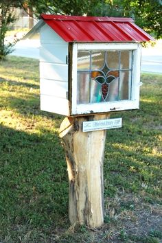 a bird house with stained glass in the window