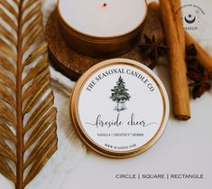 the personal candle is next to some cinnamon sticks and an evergreen tree in a jar