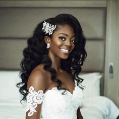 a woman in a wedding dress posing for a photo on the bed with her hair pulled back