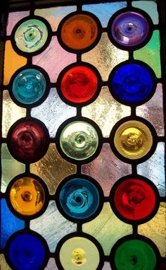 a multicolored stained glass window with many circles