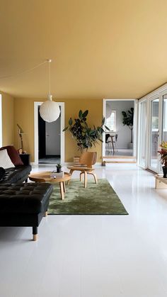 a living room filled with furniture and lots of windows