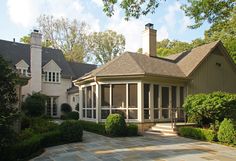 a large house with lots of windows in the front yard