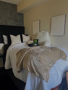 a bed with white and brown sheets in a bedroom