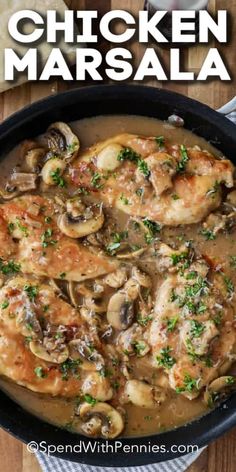 chicken marsala with mushrooms and parsley in a skillet on a wooden table