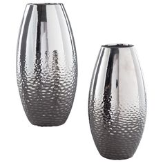 two silver vases sitting next to each other