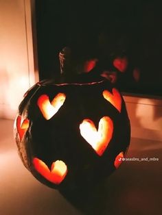 a pumpkin with hearts carved into it