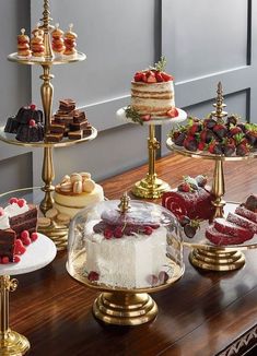 an assortment of cakes and pastries on display