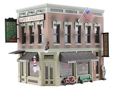 a toy model of a store front with an american flag on the roof and windows