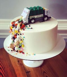 a white cake with a green truck on top