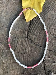 This pink and white aesthetic necklace. Seed bead choker. The beads are made of glass and they are 6mm. White Crystal Choker Necklace For Gift, White Beaded Crystal Choker Necklace, Pink Choker With Round Tiny Beads, Pink Beaded Choker For Gift, Adjustable Single Strand White Beads, White Single Strand Choker Necklace, Pink Tiny Beads Choker Necklace, Handmade Pink Choker With Round Beads, Pink Handmade Choker With Round Beads