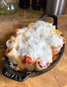 a skillet filled with pasta and cheese