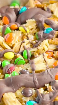 a bowl filled with lots of candy and candies on top of rice krispy treats