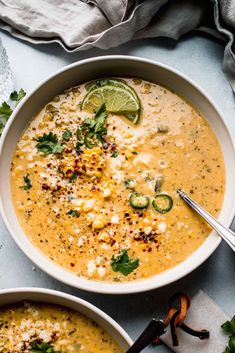 two bowls filled with soup and garnished with cilantro