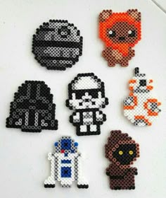 six pixelated star wars magnets on a white surface