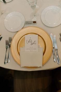 a table set with place cards and silverware