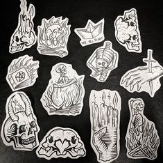 several stickers with different designs on them sitting on a black surface in front of a white background