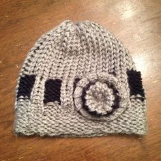 a knitted hat sitting on top of a wooden table