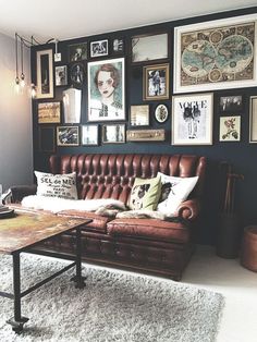 a living room filled with furniture and lots of pictures on the wall above it's coffee table