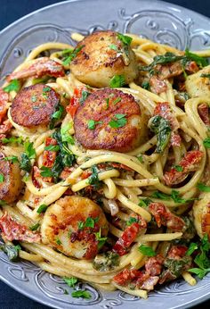 pasta with scallops and tomatoes in a bowl