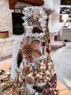 a table topped with lots of different types of brooches and pearls on top of it